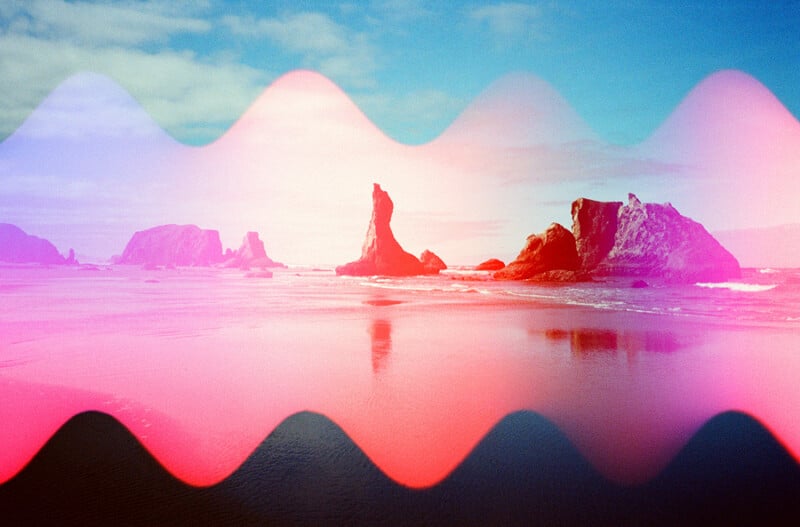 A coastal beach scene with large rock formations is overlaid with a bright, wavy pink and purple light leak effect.
