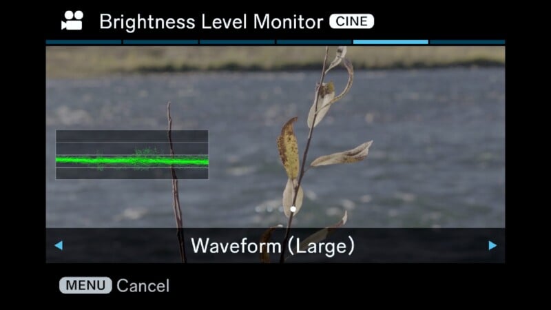 A camera menu screen displays the "Brightness Level Monitor" setting with "Waveform (Large)" selected, showing a preview of a river scene with a waveform overlay.