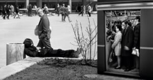 A split-screen image showing a person lying on a concrete ledge outdoors on the left and commuters standing in a subway car on the right.