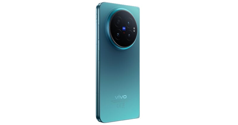 A teal-colored smartphone shown from a rear-angled perspective, featuring a large circular camera module with ZEISS branding and a vivo logo on the lower back panel.