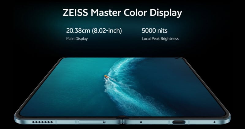A foldable smartphone is shown open, displaying a blue ocean scene with a small boat, with text above stating "ZEISS Master Color Display," "20.38cm (8.02-inch) Main Display," and "5000 nits Local Peak Brightness.