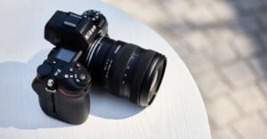 A Nikon Z6II camera with a Tamron 20-40mm f/2.8 lens sits on a white circular table outdoors.