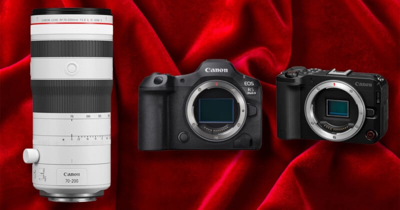 A white Canon RF 70-200mm lens, a Canon EOS R5 Mark II camera body, and a Canon EOS R camera body are arranged against a red velvet background.