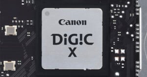 A Canon DiG!C X image processor chip mounted on a black circuit board with various small electronic components.