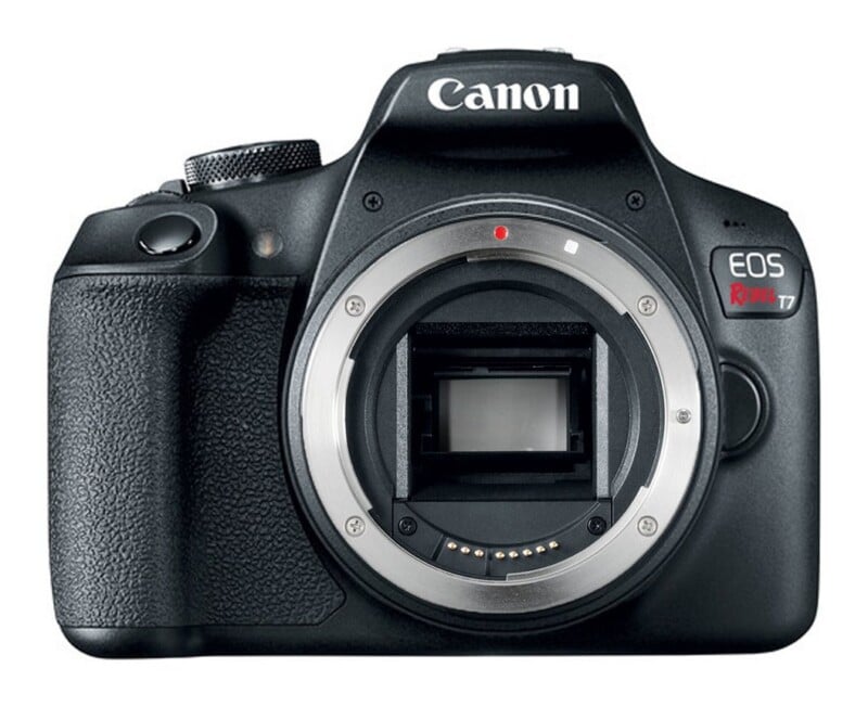 A black Canon EOS Rebel T7 DSLR camera body shown from the front without a lens attached.