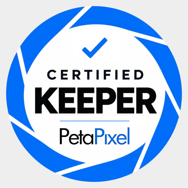 A circular logo with a blue camera aperture design, featuring a blue checkmark above the text "CERTIFIED KEEPER" and "PetaPixel".