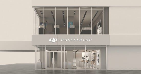 A two-story storefront with floor-to-ceiling glass windows and a sign reading "DJI | HASSELBLAD" above the entrance.