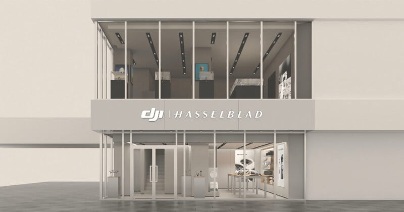 A two-story storefront with floor-to-ceiling glass windows and a sign reading "DJI | HASSELBLAD" above the entrance.