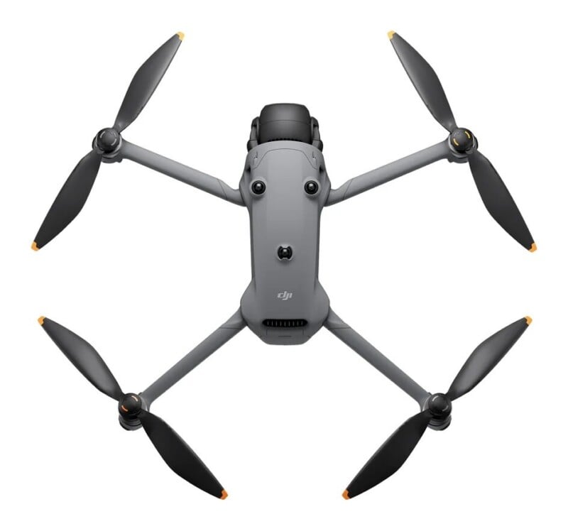 A top-down view of a grey quadcopter drone with four propellers, showing its central body, camera gimbal at the front, and obstacle avoidance sensors.