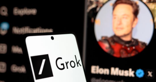 A smartphone screen displays the Grok logo in the foreground, with a blurred profile of Elon Musk on the X platform visible in the background.