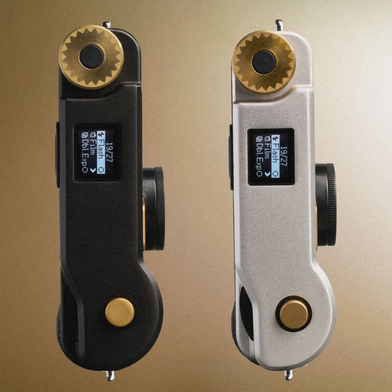 Two film cameras, one black and one silver, are shown from a top-down perspective against a gradient background, each featuring a digital display, a brass-colored winding knob, and a shutter button.