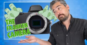 A man with graying hair and a beard gestures toward a camera body flanked by cartoon monster hands, with the text "THE FRANKEN CAMERA" in green slime-style lettering.
