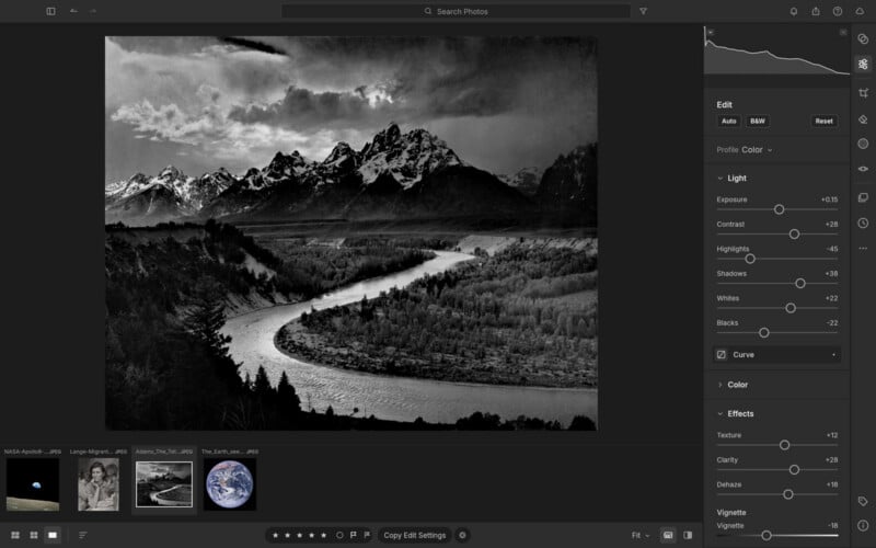 A computer screen displays a photo editing interface showing a black-and-white landscape of a river winding through a valley toward snow-capped mountains.