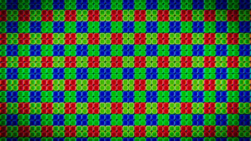 A close-up view of a digital display screen showing a repeating grid pattern of red, green, and blue subpixels.