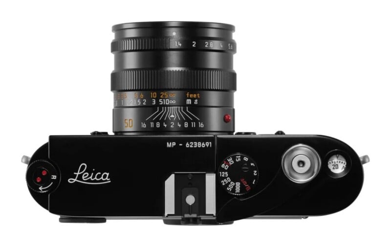 Top-down view of a black Leica MP camera with a 50mm lens attached, showing the shutter speed dial, film advance lever, and frame counter.