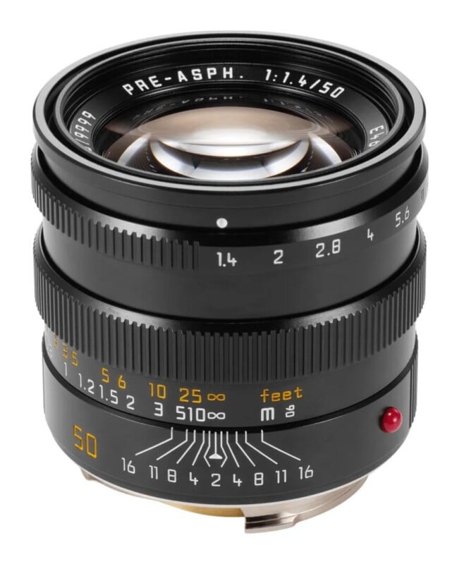 A black camera lens with a 50mm focal length and 1.4 aperture, featuring focus and depth-of-field scales in yellow and white.