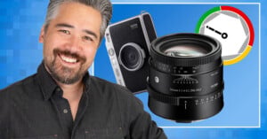 A smiling man with graying hair stands next to a Fujifilm Instax Mini Evo camera, a Sigma 50mm lens, and a circular aperture-themed graphic on a blue background.