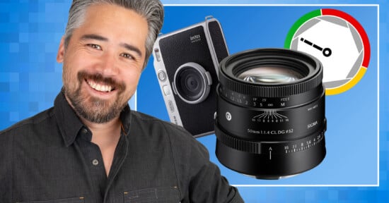A smiling man with graying hair stands next to a Fujifilm Instax Mini Evo camera, a Sigma 50mm lens, and a circular aperture-themed graphic on a blue background.