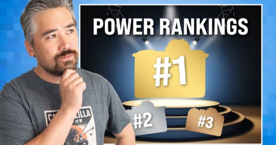 A man with a beard and graying hair looks thoughtfully at a graphic titled "POWER RANKINGS" that displays three camera silhouettes ranked #1, #2, and #3.