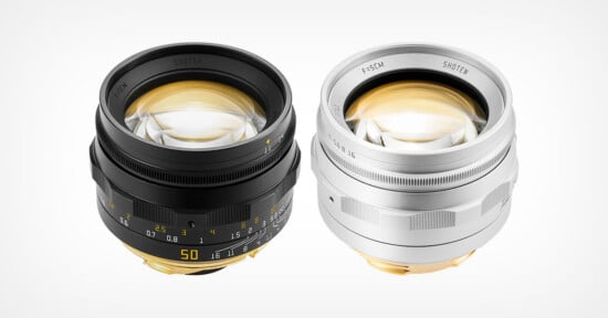 Two manual focus camera lenses, one black and one silver, are positioned side-by-side against a plain white background.