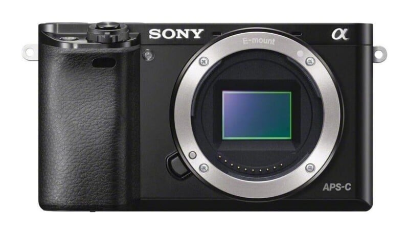 A black Sony Alpha mirrorless camera body with an E-mount lens opening and an APS-C sensor visible on the front.