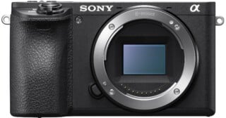 A front view of a black mirrorless camera body with an E-mount lens opening and a visible rectangular sensor.