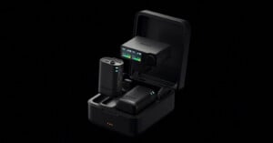 A Sony wireless microphone system with two transmitters and a receiver inside an open black charging case against a black background.