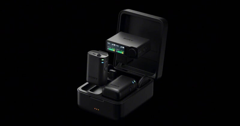 A Sony wireless microphone system with two transmitters and a receiver inside an open black charging case against a black background.