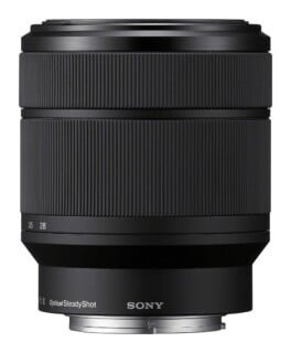 A black Sony camera lens with a ribbed focus ring, marked with focal lengths 28 and 35, and the text "OpticalSteadyShot" near the metal mount.
