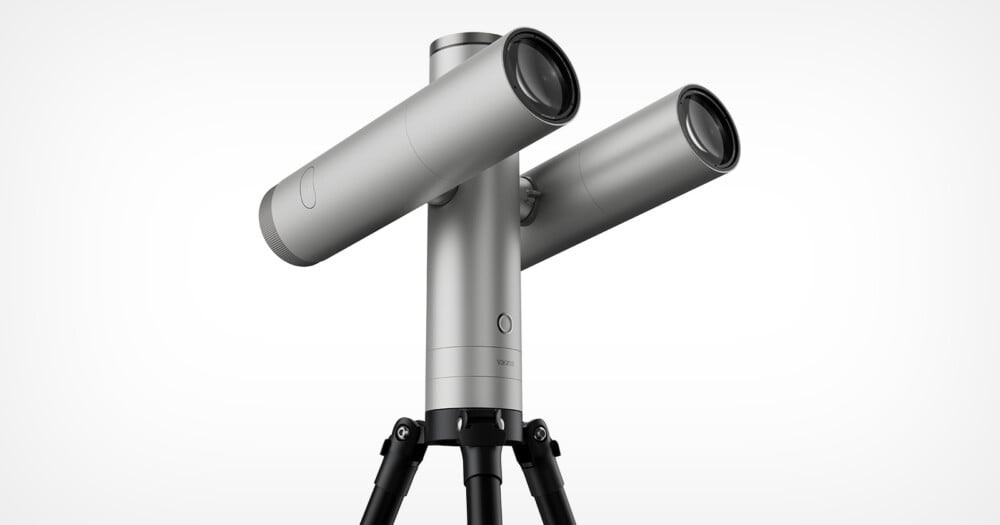 A silver, dual-lens telescope mounted on a black tripod against a white background, with the word "vaonis" printed on the central pillar.