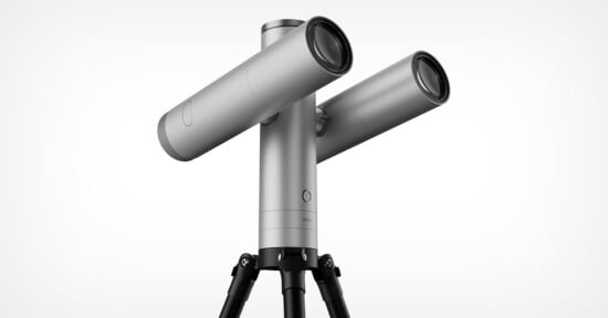 A silver, dual-lens telescope mounted on a black tripod against a white background, with the word "vaonis" printed on the central pillar.