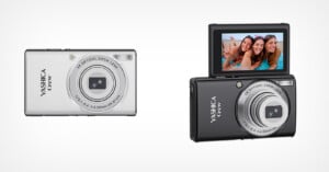 Two Yashica Crew digital cameras, one silver and one black, shown side-by-side with the black camera featuring a flip-up screen.